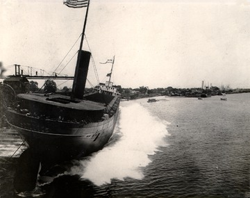 Hemlock - Stern view of a starboard side launch in 1907. This is the traditional method for launching Great Lakes ships. Note the men riding on the stern.