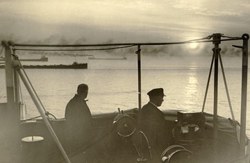 Keewatin - View from open bridge, ore carriers off to port, equipment visible, canvas cover for bridge also visible.