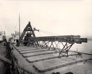 Deck view, looking forward, note unloading boom and conveyor box, and hatchcovers.