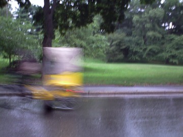 Bicyclist with Yellow Raincoat. New York, Central Park, August 2011 